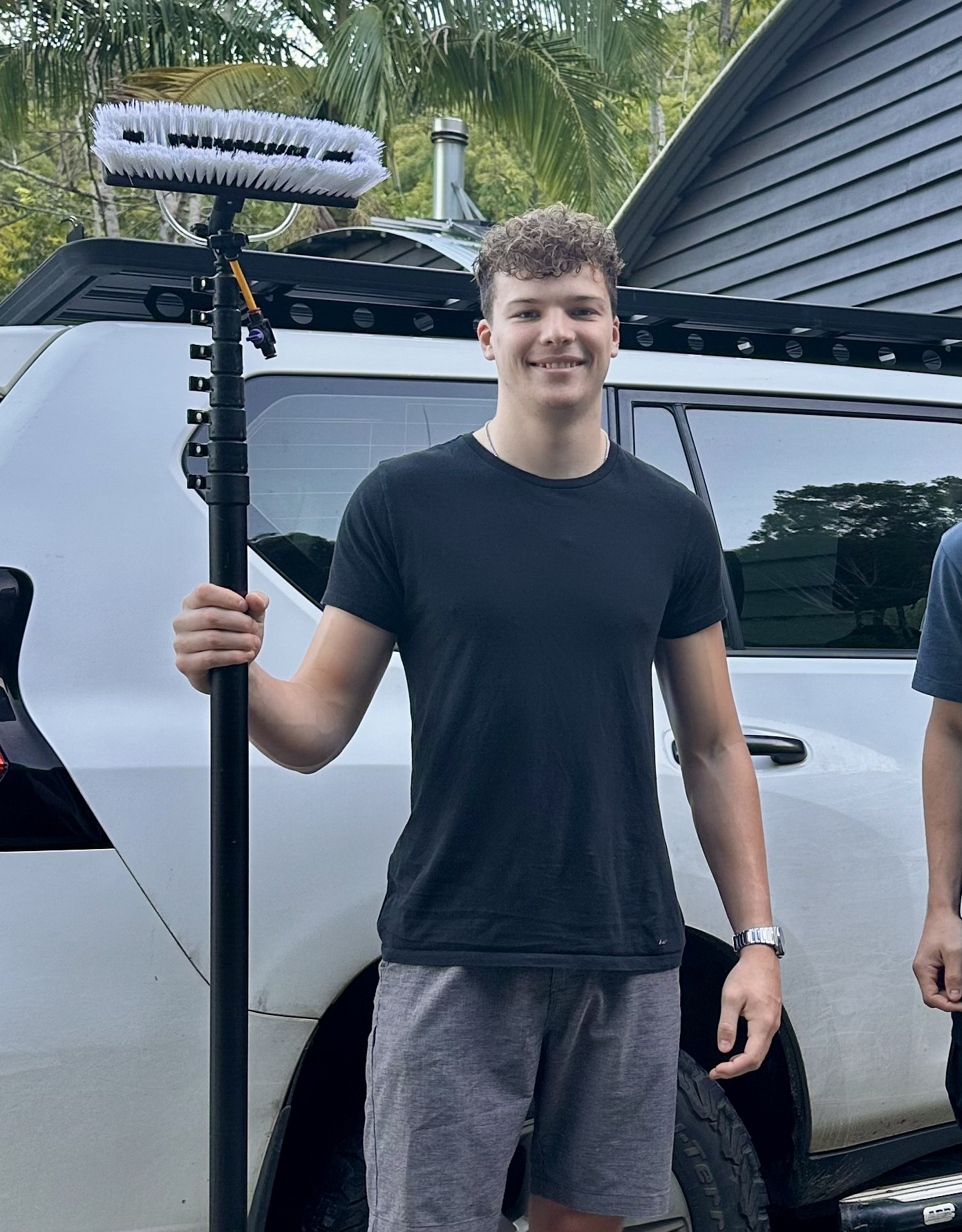Blair with his window cleaning gear beside his work vehicle on the Gold Coast